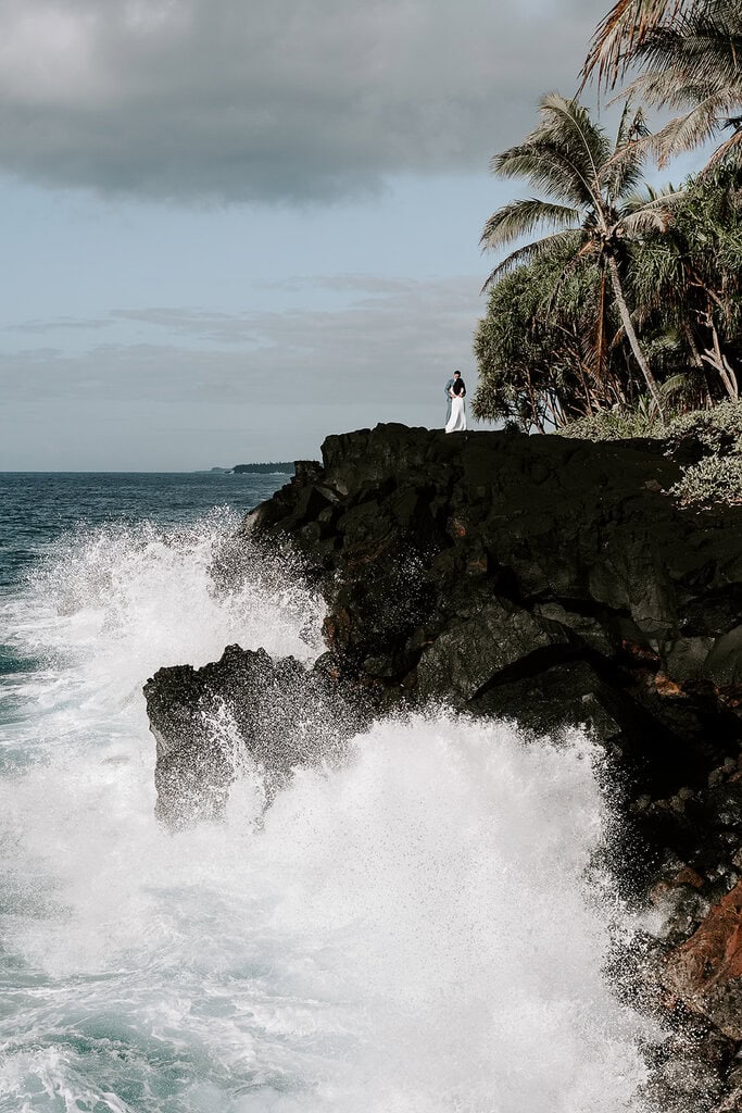 newlyweds hugging on a cliff during their Big Island elopement.