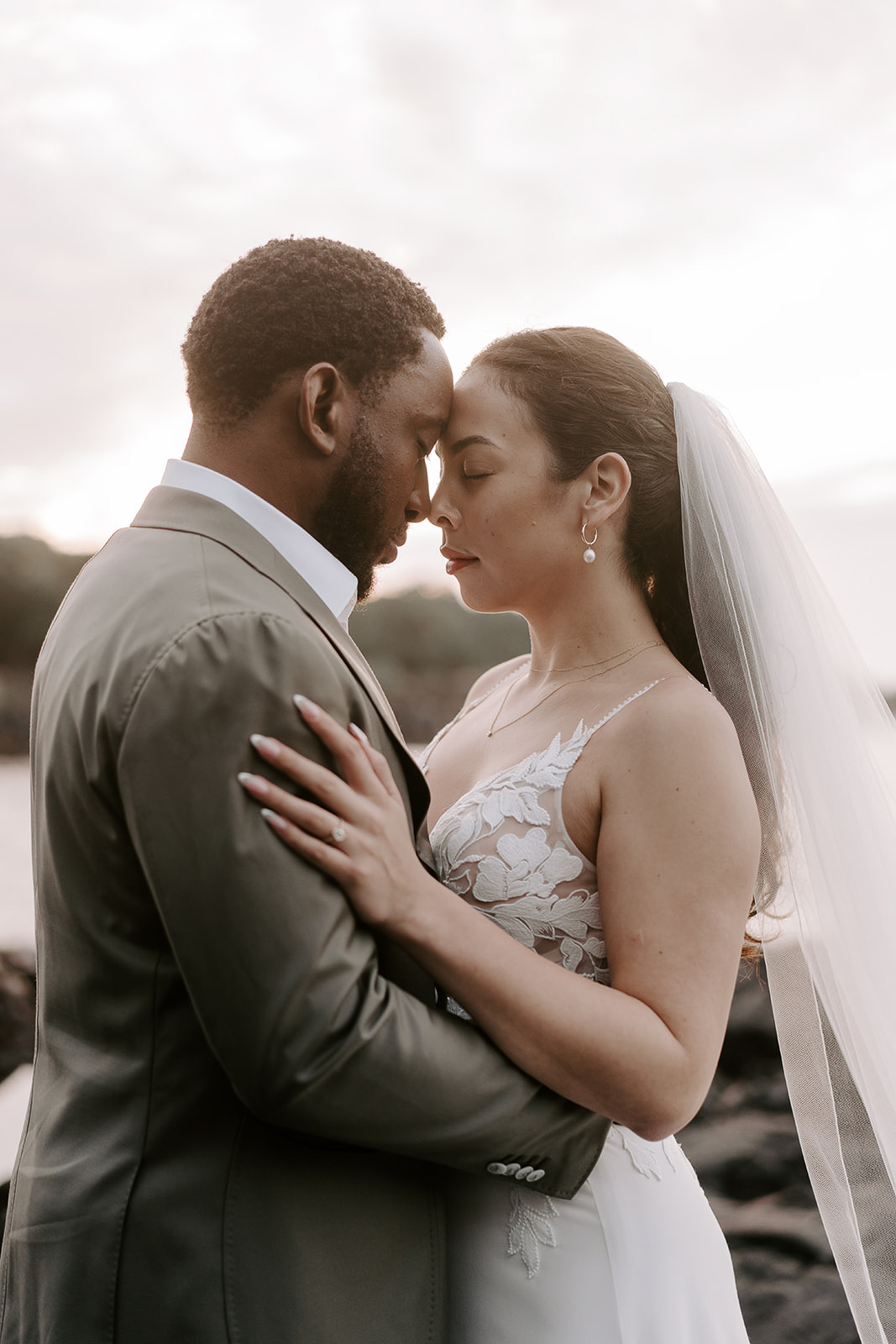 newlyweds hugging at sunset.