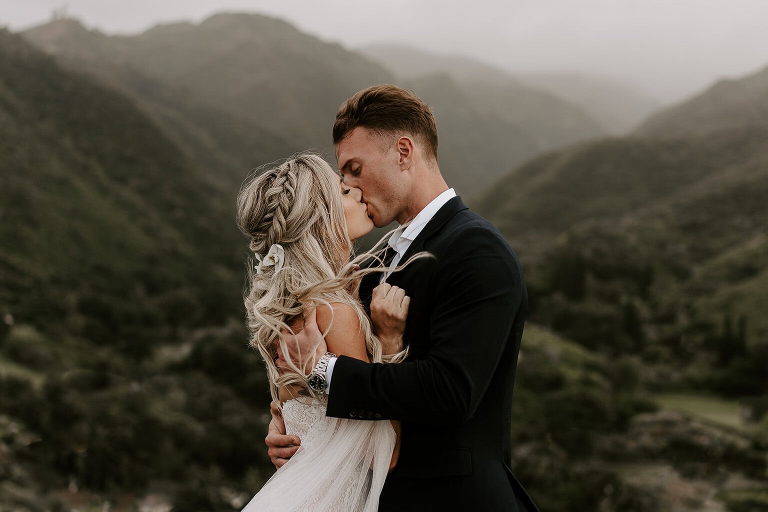 newlyweds kissing in the mountains during their Maui elopement.
