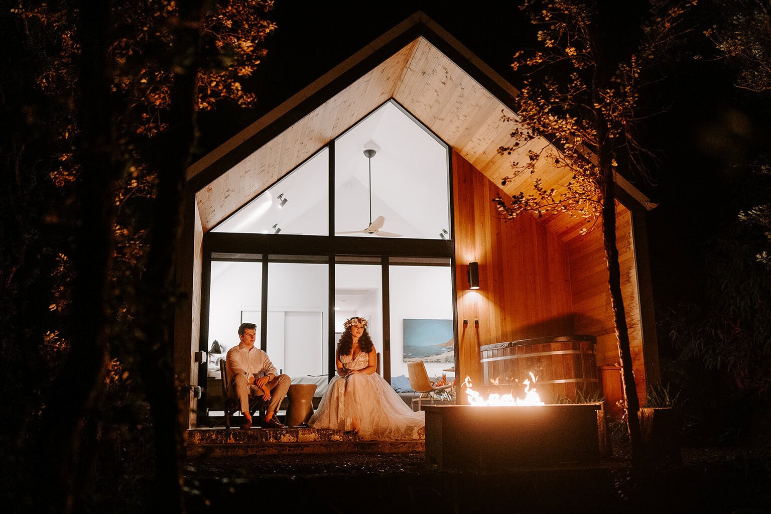 newlyweds enjoying the fireplace of their Airbnb during their Volcanoes National Park wedding.