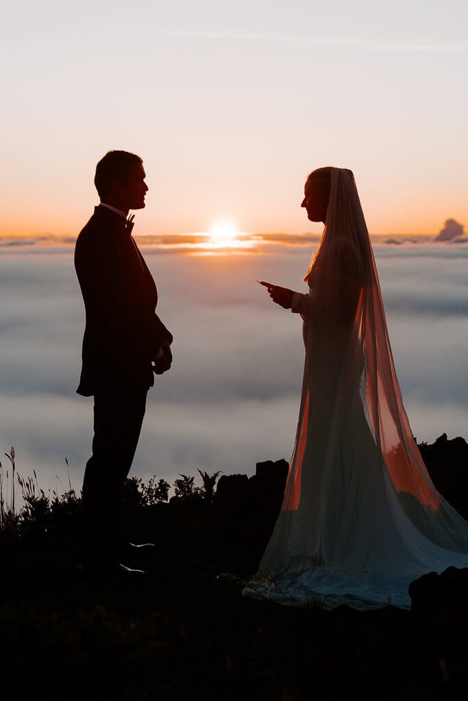 newlyweds exchanging vows at sunset during their Haleakalā wedding.