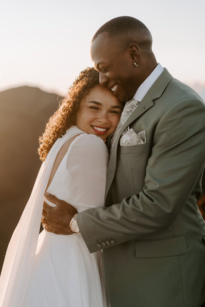 newlyweds hugging each other close.