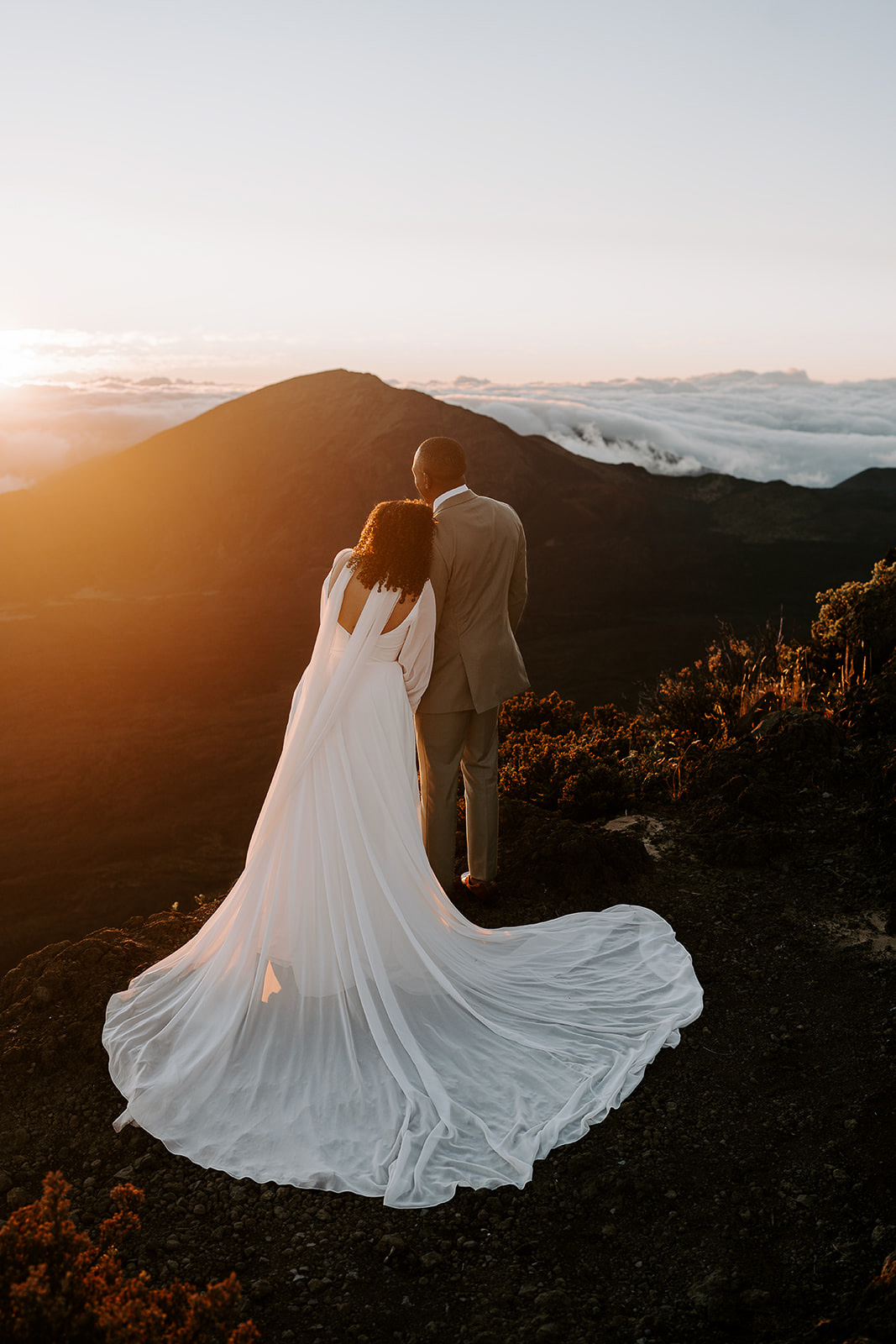 newlyweds talking in the sunrise during their Haleakalā wedding.