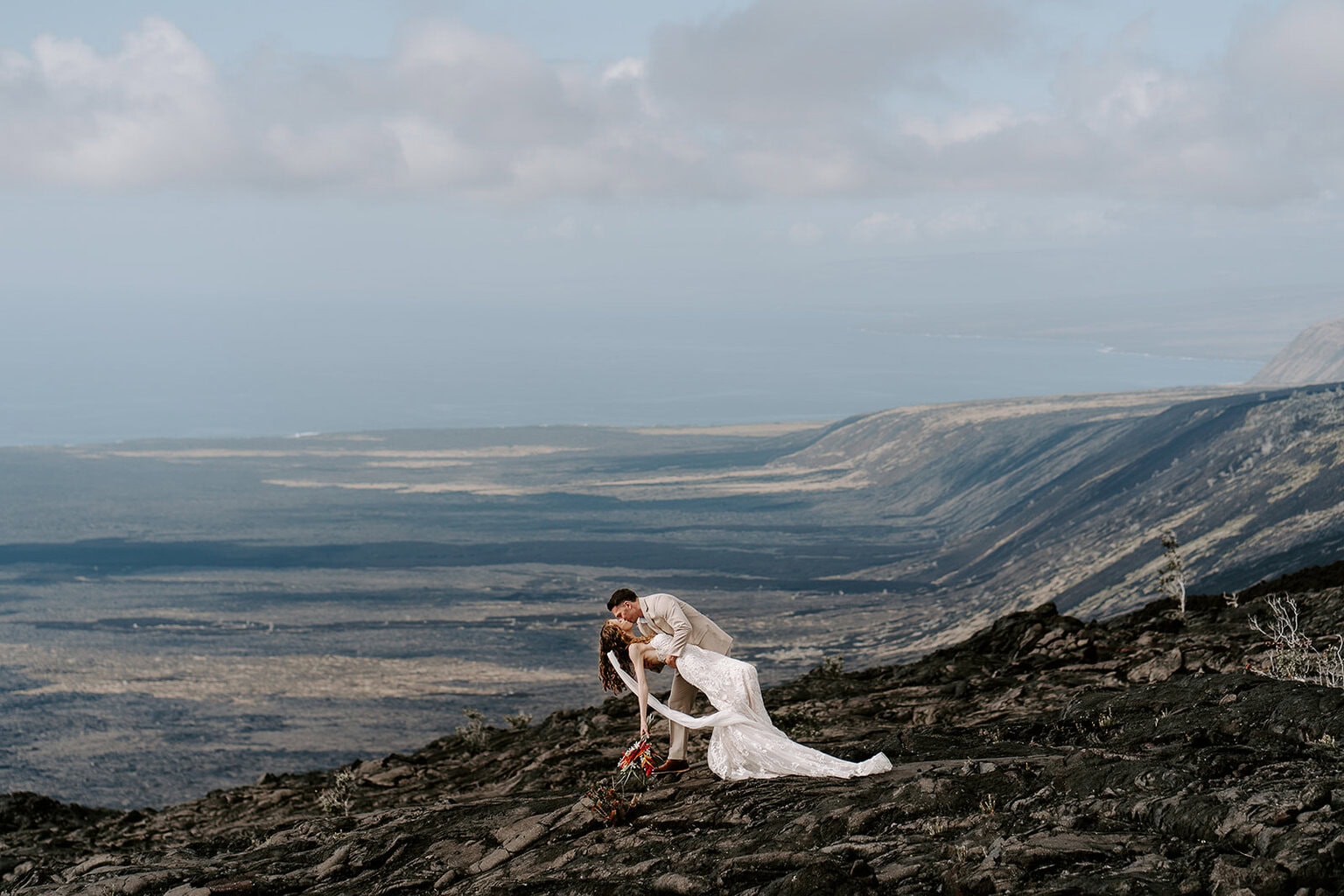 newlyweds kissing on a Lava Field by Volcanoes National Park, one of the best places to get married on the Big Island.