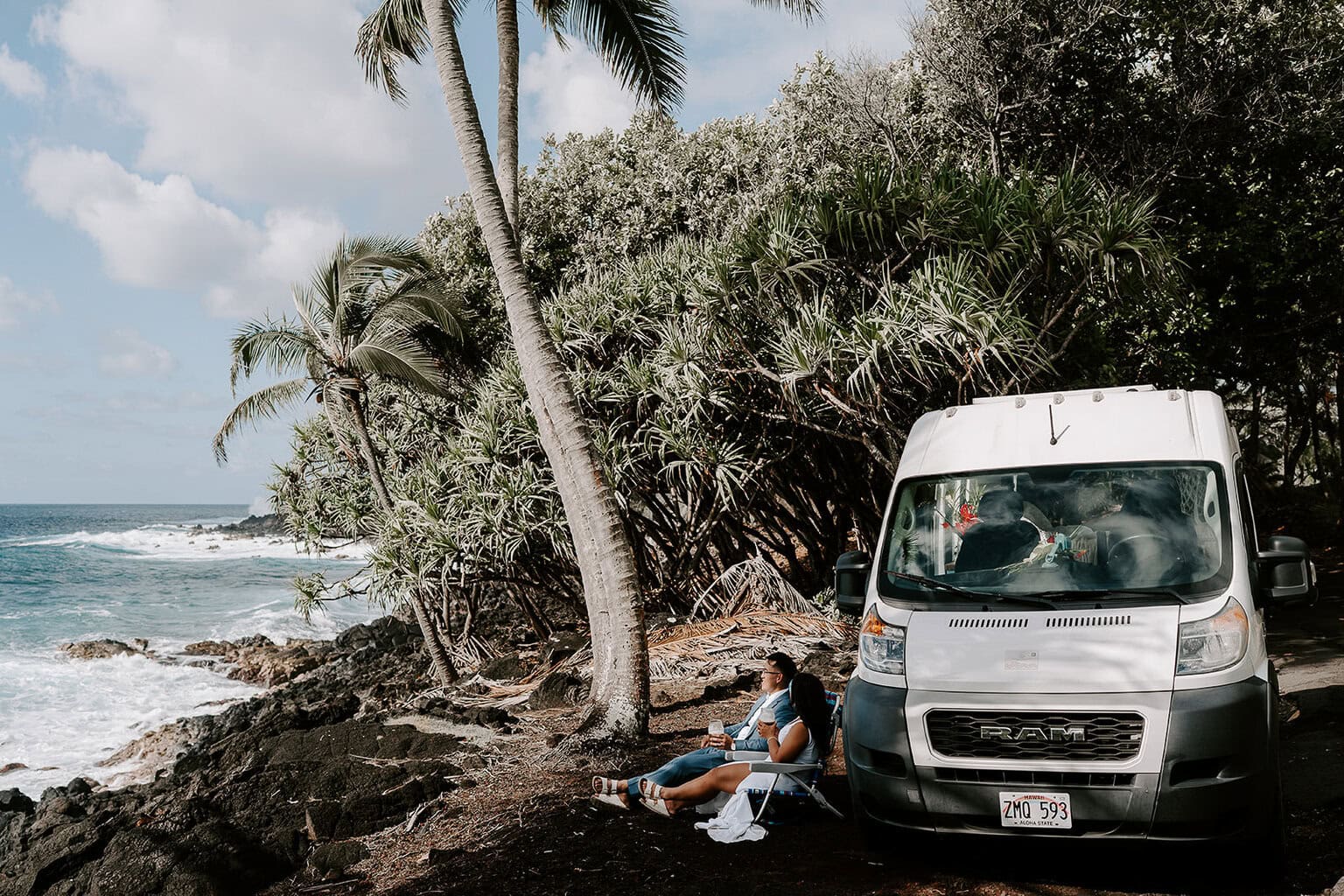 newlyweds soaking in the view of the ocean by their camper van as they get married on the Big Island.