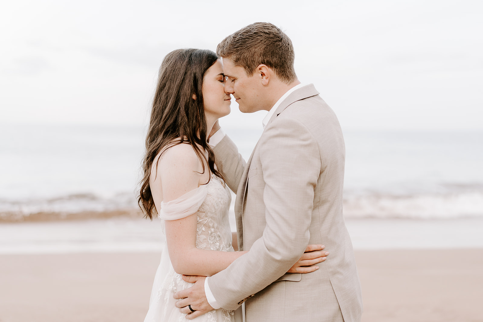 newlywed about to kiss on the beach on Maui. 