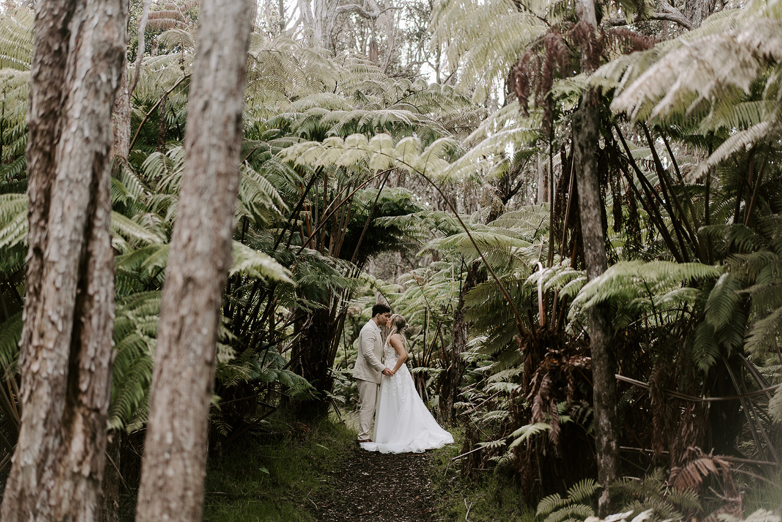 newlyweds kissing in the jungle, one of the best places to get married on the Big Island. 