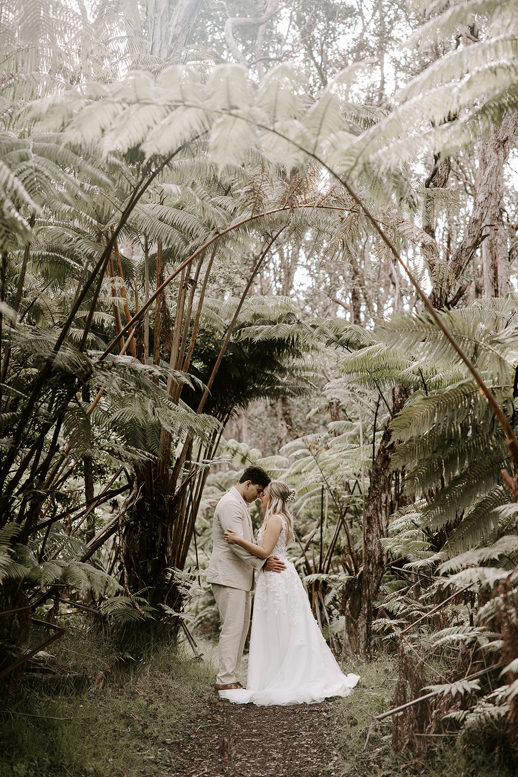 newlyweds hugging in the Jungle in Hawaii.