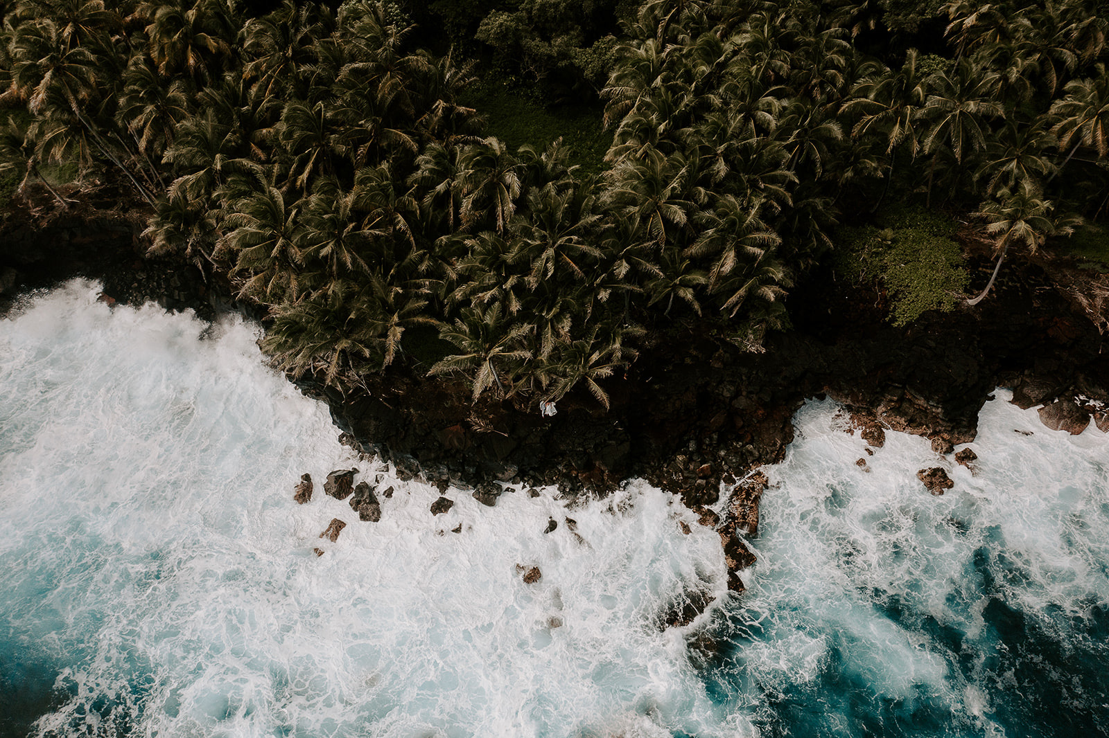waves crashing into a black cliffside, one of the best places to get married on the Big Island.