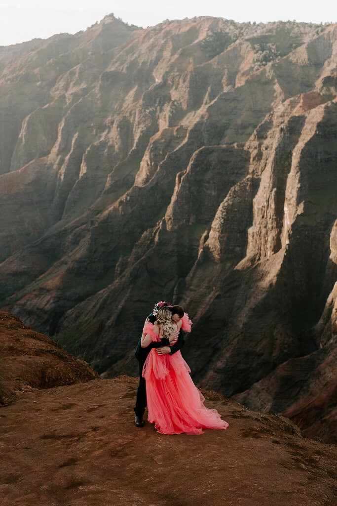 newlyweds hugging during golden hour as they elope in Waimea Canyon
