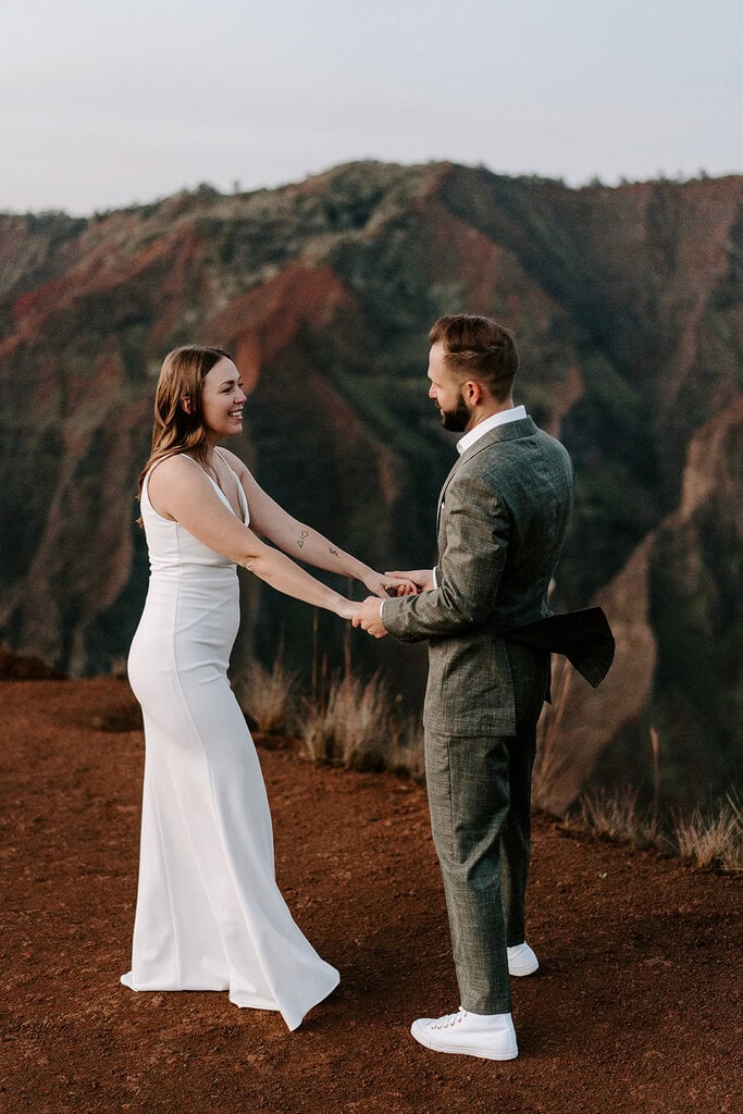 Newlyweds dancing during golden hour as they elope in Waimea Canyon
